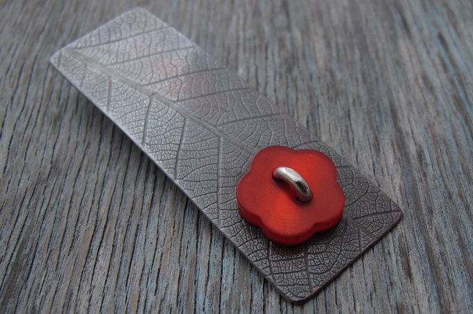 Red Button Riveted to Copper